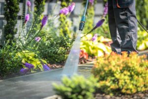 Power Washing Garden Cobble Stone Paths. Outdoor Cleaning Using Pressure Washer. Closeup Photo.