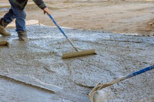 Workers used various tools to ensure proper leveling of poured concrete.